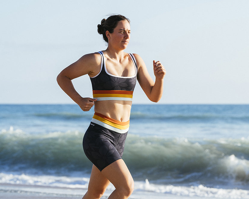 The surfer Tyler Wright running at the beach