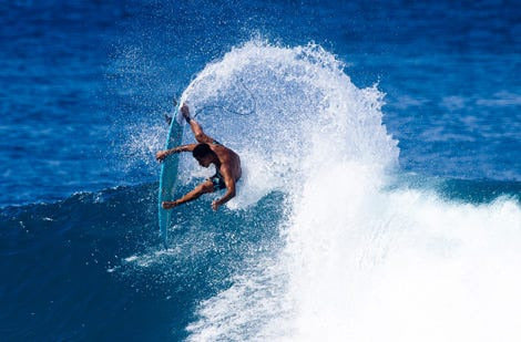 Surfer on ocean making an aerial