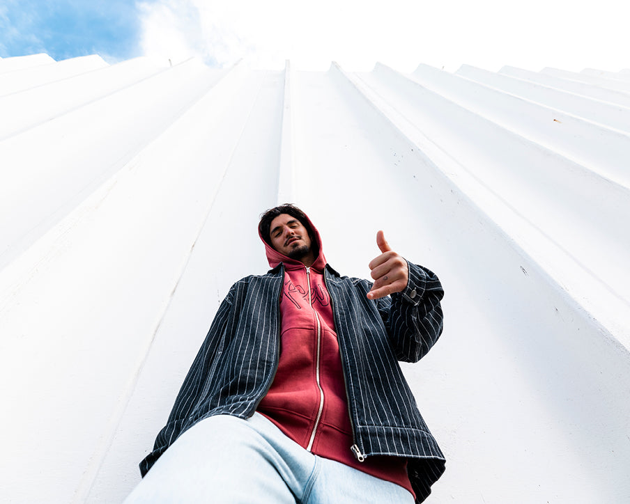 Person giving a thumbs up in front of a white architectural structure