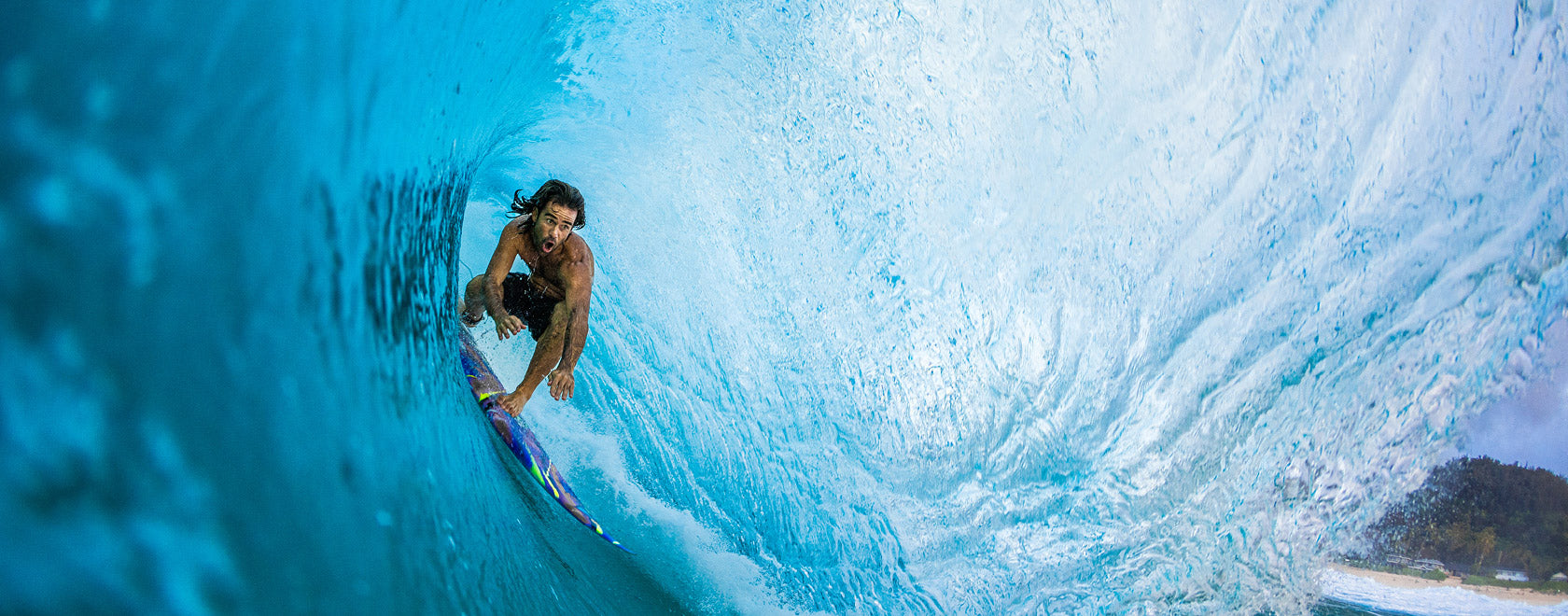 Person surfing inside a large wave tunnel