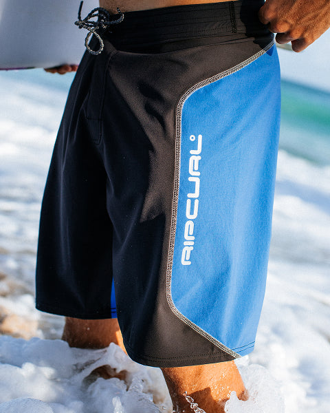 Person wearing black and blue shorts.