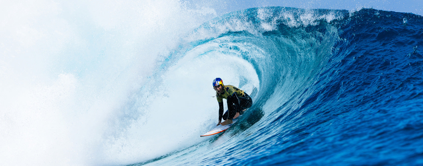 Surfer riding a large wave in the ocean