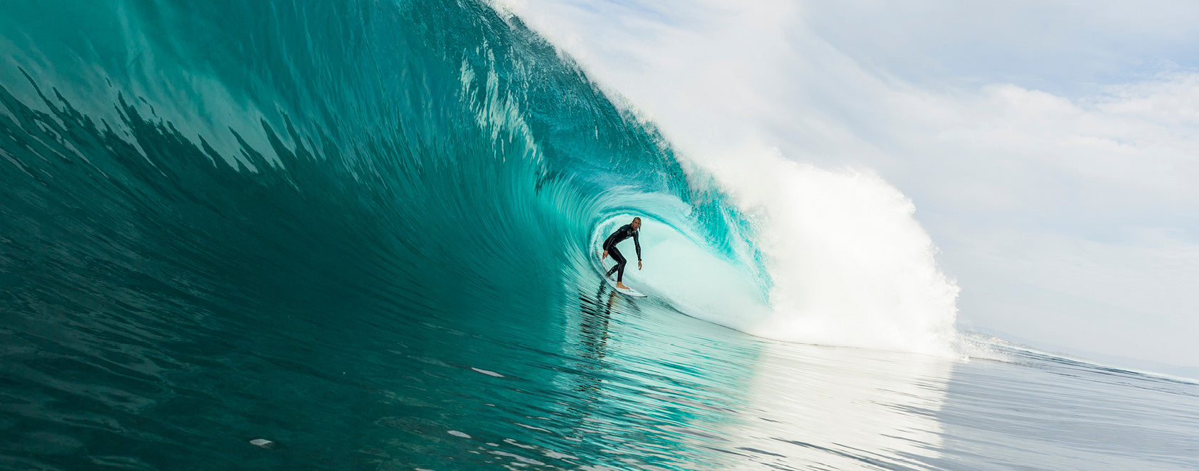 Surfer riding a large wave in the ocean