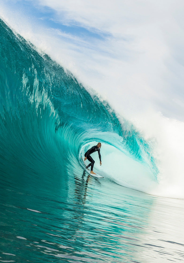 Surfer riding a large wave in the ocean