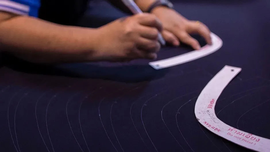 Person using a measuring tool on a dark surface